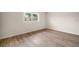 Bright bedroom with wood-look floors and a window at 3100 Hartford N St # 224, St Petersburg, FL 33713