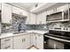 Modern kitchen with stainless steel appliances and gray cabinets at 3100 Hartford N St # 224, St Petersburg, FL 33713