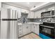 Modern kitchen with stainless steel appliances and gray cabinets at 3100 Hartford N St # 224, St Petersburg, FL 33713