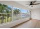 Screened lanai with wood-look flooring and windows offering a garden view at 3100 Hartford N St # 224, St Petersburg, FL 33713