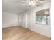 Light-filled living room featuring wood-look floors and multiple windows at 3100 Hartford N St # 224, St Petersburg, FL 33713
