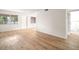 Spacious living area showcasing wood-look floors and access to other rooms at 3100 Hartford N St # 224, St Petersburg, FL 33713