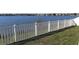 White vinyl fence provides privacy along the lake at 31217 Triborough Dr, Wesley Chapel, FL 33545