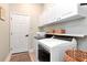 Bright laundry room with washer, dryer, and ample storage at 3812 Misty Landing Dr, Valrico, FL 33594