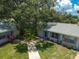 Two tan houses with blue shutters and a shared yard at 402 Dorchester Pl # 28, Sun City Center, FL 33573