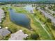Golf course community with houses and a lake at 402 Dorchester Pl # 28, Sun City Center, FL 33573