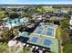 Community pool, pickleball courts, and lush landscaping are featured in this beautiful aerial view at 402 Dorchester Pl # 28, Sun City Center, FL 33573