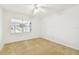 Bedroom with window, ceiling fan and carpet at 402 Dorchester Pl # 28, Sun City Center, FL 33573