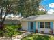 Tan house with blue shutters and walkway, green lawn at 402 Dorchester Pl # 28, Sun City Center, FL 33573