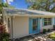 Tan house with blue shutters and walkway at 402 Dorchester Pl # 28, Sun City Center, FL 33573