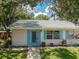 Tan house with blue shutters, walkway, and landscaping at 402 Dorchester Pl # 28, Sun City Center, FL 33573