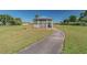 White gazebo with benches on a paved path at 402 Dorchester Pl # 28, Sun City Center, FL 33573