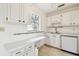 Full view of kitchen with white cabinets and appliances at 402 Dorchester Pl # 28, Sun City Center, FL 33573