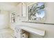 Kitchen with white cabinets and a window at 402 Dorchester Pl # 28, Sun City Center, FL 33573