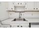 Stainless steel sink with white cabinets and countertops at 402 Dorchester Pl # 28, Sun City Center, FL 33573