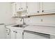 Stainless steel sink with white cabinets and countertops at 402 Dorchester Pl # 28, Sun City Center, FL 33573