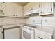 White cabinets, stove, and oven in this kitchen at 402 Dorchester Pl # 28, Sun City Center, FL 33573