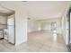Open living room with tile floor and kitchen access at 402 Dorchester Pl # 28, Sun City Center, FL 33573