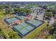 Aerial view of community pickleball courts with covered seating areas at 402 Dorchester Pl # 28, Sun City Center, FL 33573