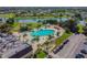 Aerial view of resort-style pool with surrounding lounge chairs and landscaping at 402 Dorchester Pl # 28, Sun City Center, FL 33573