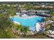 Resort-style pool with surrounding lounge chairs and palm trees at 402 Dorchester Pl # 28, Sun City Center, FL 33573
