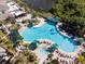 Relaxing pool area with hot tub and green umbrellas at 402 Dorchester Pl # 28, Sun City Center, FL 33573