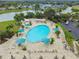 Resort-style pool with ample lounge chairs and umbrellas at 402 Dorchester Pl # 28, Sun City Center, FL 33573