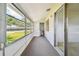 Bright screened porch with carpeted floor at 402 Dorchester Pl # 28, Sun City Center, FL 33573