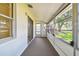 Bright screened porch with carpeted floor and view at 402 Dorchester Pl # 28, Sun City Center, FL 33573