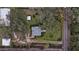 House nestled in a wooded area with a large yard at 4156 Mcintosh Rd, Dover, FL 33527