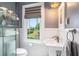 Updated bathroom with subway tile, pedestal sink, and window with a view at 4156 Mcintosh Rd, Dover, FL 33527