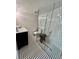 Modern bathroom with subway tile, glass shower, and black and white floor at 4156 Mcintosh Rd, Dover, FL 33527