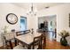 Bright dining room features a spacious table, hardwood floors, and a view into the living room at 4156 Mcintosh Rd, Dover, FL 33527