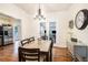 Bright dining room features a spacious table, hardwood floors, and a view into the kitchen at 4156 Mcintosh Rd, Dover, FL 33527