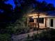 Cottage with pergola, lights, and landscaping at night at 4156 Mcintosh Rd, Dover, FL 33527