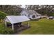 White cottage with covered well and spacious yard at 4156 Mcintosh Rd, Dover, FL 33527