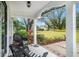 Relaxing front porch with wicker chairs and view of yard at 4156 Mcintosh Rd, Dover, FL 33527