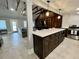 Modern kitchen with island, dark cabinetry, and exposed beams at 4156 Mcintosh Rd, Dover, FL 33527