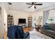 Living room with hardwood floors, gray sofa, and TV at 4156 Mcintosh Rd, Dover, FL 33527