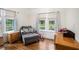 Home office with hardwood floors, ample natural light, and comfortable seating at 4156 Mcintosh Rd, Dover, FL 33527