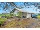 White outbuilding with covered patio, seating area, and attached garage at 4156 Mcintosh Rd, Dover, FL 33527
