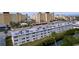 Aerial view of a condo building near waterway, with taller buildings in background at 4455 Duhme Rd # 303, St Petersburg, FL 33708