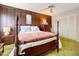 Spacious bedroom with a wooden four-poster bed and ample closet space at 4455 Duhme Rd # 303, St Petersburg, FL 33708