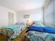 Guest bedroom with twin beds, featuring a coastal theme at 4455 Duhme Rd # 303, St Petersburg, FL 33708
