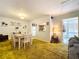 Dining area with adjacent kitchen and access to lanai at 4455 Duhme Rd # 303, St Petersburg, FL 33708