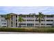 Two-story residential building with palm trees and landscaping at 4455 Duhme Rd # 303, St Petersburg, FL 33708