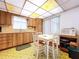 Kitchen with wood cabinets, floral ceiling, and breakfast nook at 4455 Duhme Rd # 303, St Petersburg, FL 33708
