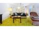 Living room with green shag carpet, sofa, and armchair at 4455 Duhme Rd # 303, St Petersburg, FL 33708