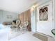 Cozy screened porch furnished with white wicker furniture at 4455 Duhme Rd # 303, St Petersburg, FL 33708