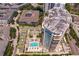 Aerial view showcasing a luxury highrise building and resort-style pool at 450 Knights Run Ave # 705, Tampa, FL 33602